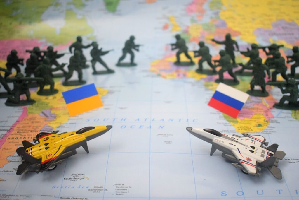 Toy soldiers and jets on world map with flags