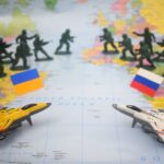 Toy soldiers and jets on world map with flags