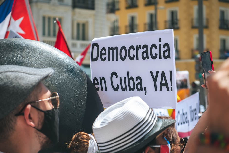 A vibrant street protest advocating for democracy in Cuba with visible signs.