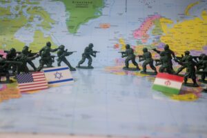 Toy soldiers face off on world map with flags.