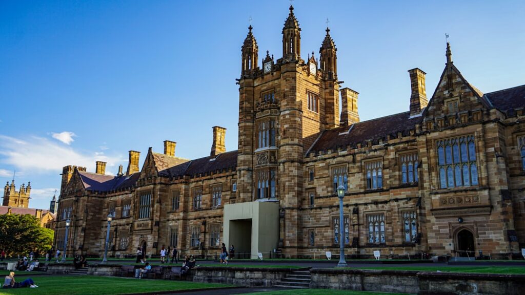 Historic stone university building with towers and blue sky