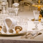 An elegantly set dining table with crystal glassware and ornate decor, ideal for formal occasions.