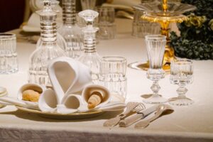 An elegantly set dining table with crystal glassware and ornate decor, ideal for formal occasions.