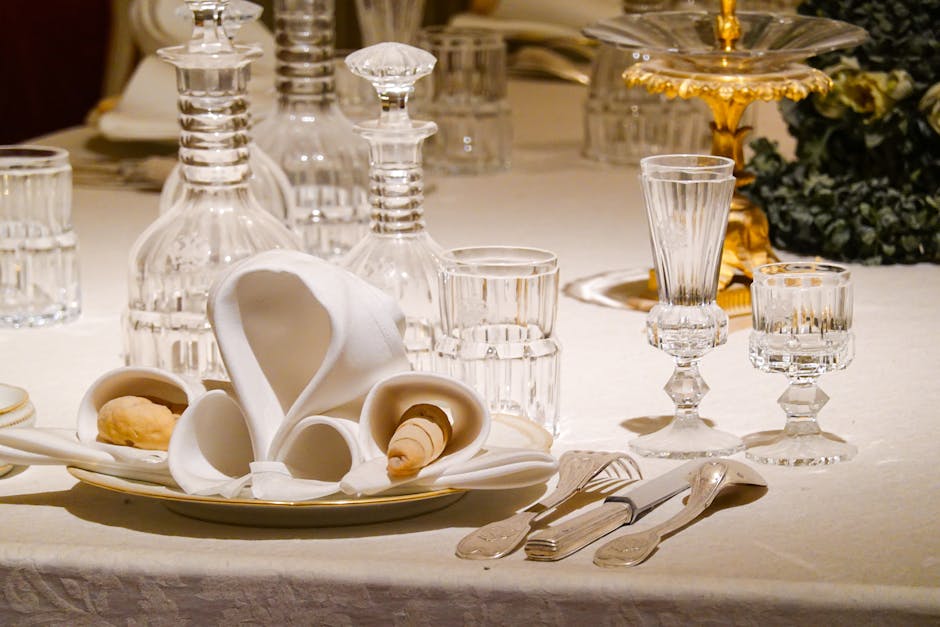 An elegantly set dining table with crystal glassware and ornate decor, ideal for formal occasions.