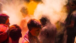 People covered in colored powder celebrating a festival celebration