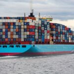 blue and red cargo ship on sea during daytime