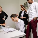 Business professionals engaged in a tense discussion at the office, highlighting workplace conflict.