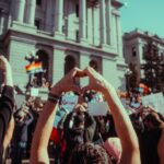 Protesters make hearts with their hands in support.