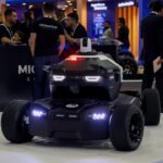 Autonomous security robot vehicle showcased at a technology exhibition, highlighting robotics innovation, smart surveill
