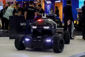 Autonomous security robot vehicle showcased at a technology exhibition, highlighting robotics innovation, smart surveill