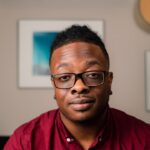 a man wearing glasses and a red shirt