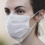 Close-up of a woman wearing a protective face mask for health safety.