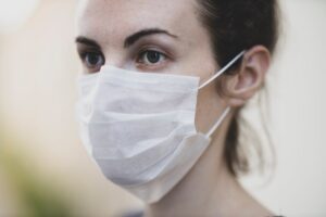 Close-up of a woman wearing a protective face mask for health safety.