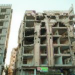Rubble and decay of a war-damaged building in Homs, Syria, highlighting urban devastation.