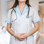Detail of stethoscope. Doctor woman with white coat and stethoscope.