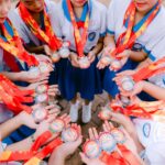 Young students proudly display medals, symbolizing achievement and teamwork.