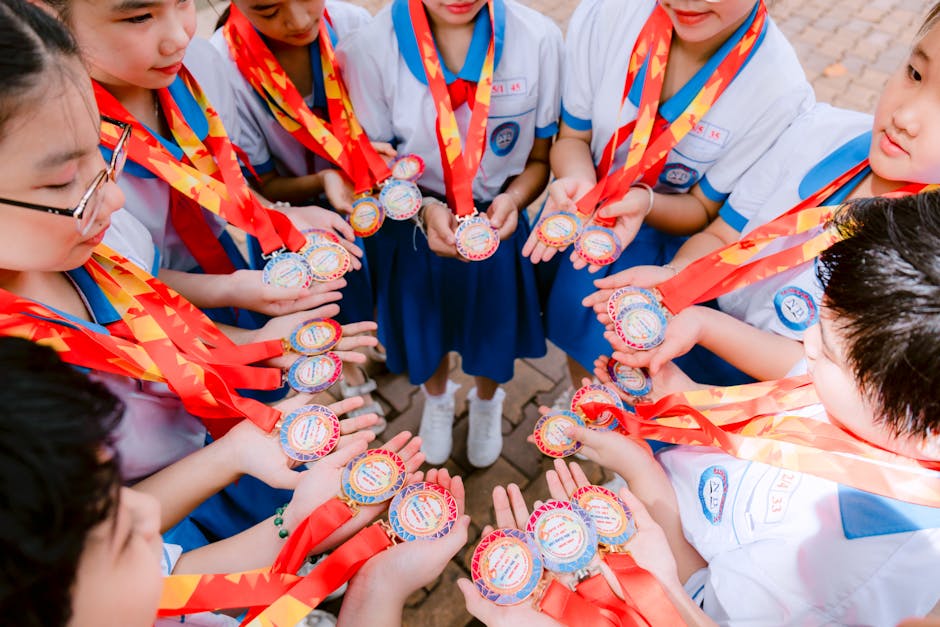 Young students proudly display medals, symbolizing achievement and teamwork.
