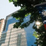 Taiwanese flag hangs near modern buildings under sunlight