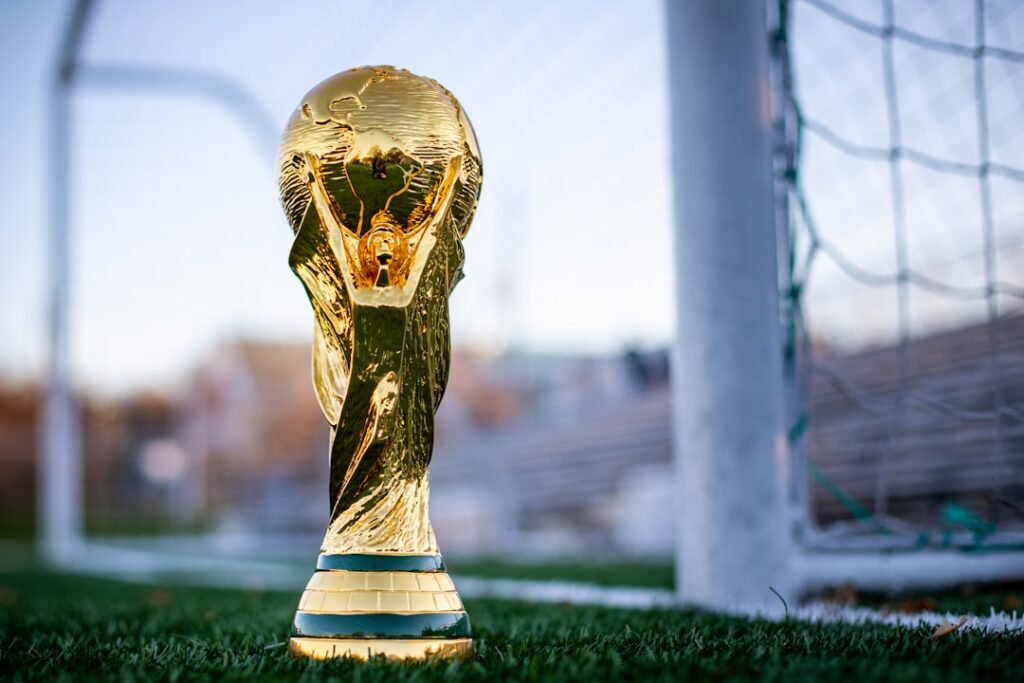 international football trophy sitting on soccer field near the goals