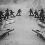 Toy soldiers and fighter jets arranged on a map.
