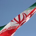 Islamic republic of Iran flag, waving over Chitgar park, lighted by evening sun. اهتزاز پرچم ایران در ارتفاعات پارک چیتگ