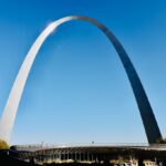 a very tall arch towering over a city